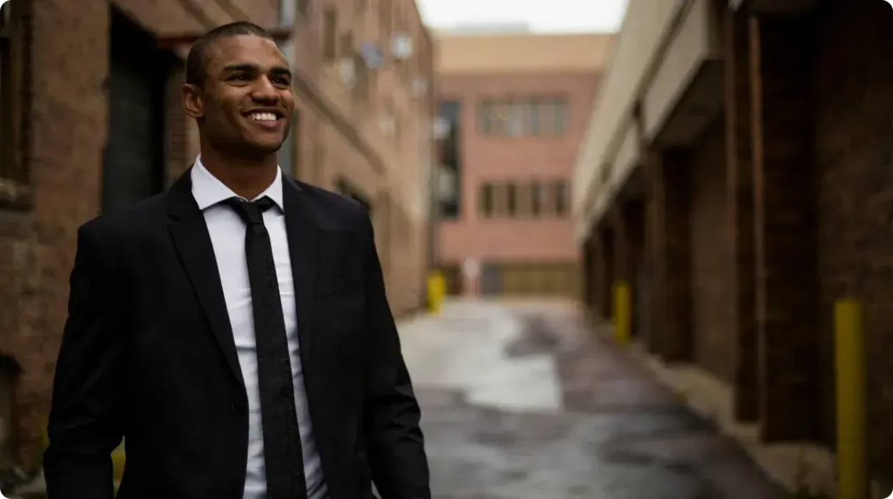 Smiling Businessman In Suit Standing Outdoors