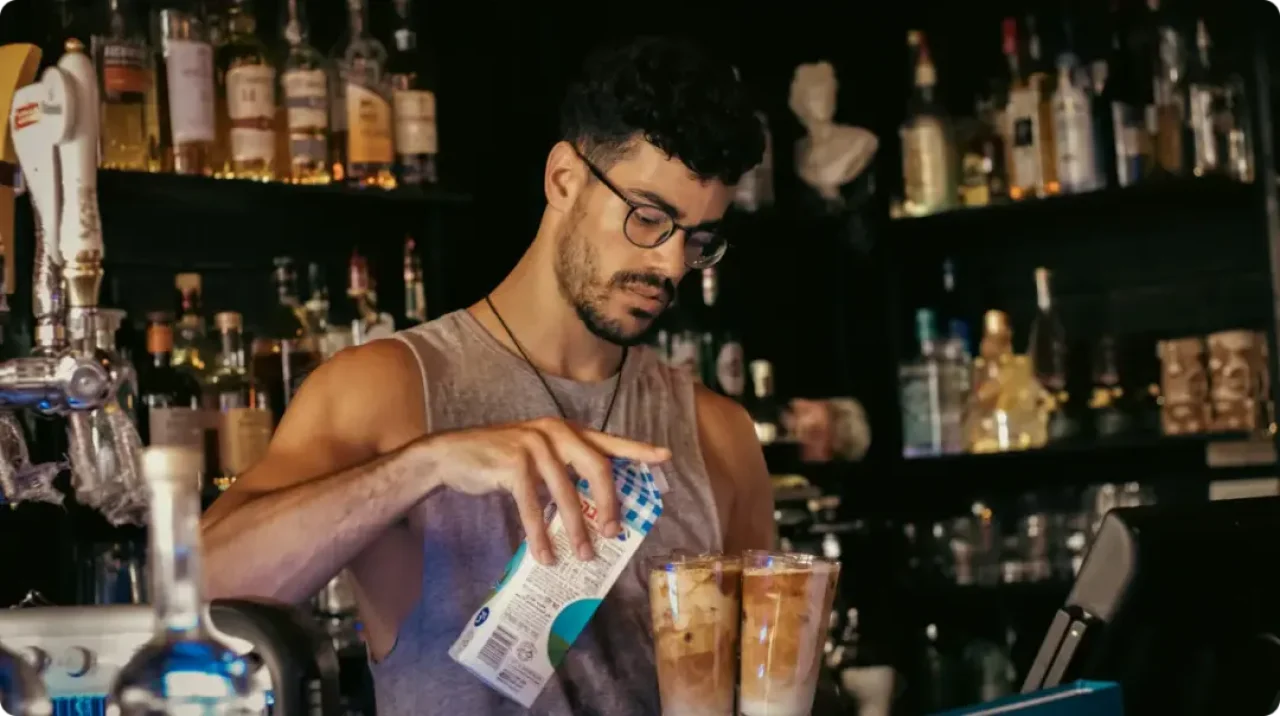 Man Adding Milk To Coffee
