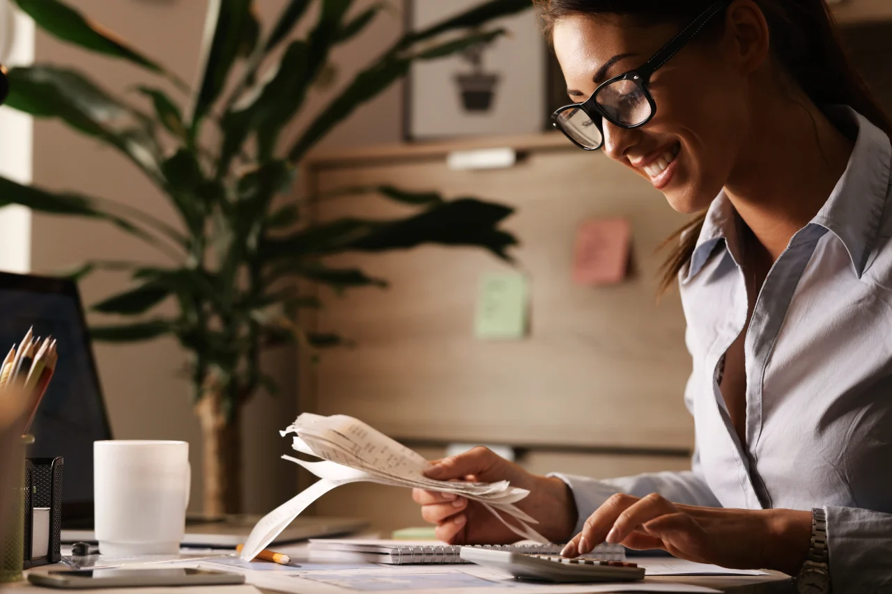 Happy Businesswoman Going Through Finances And Usi 2026 03 16 03 28 07 Utc