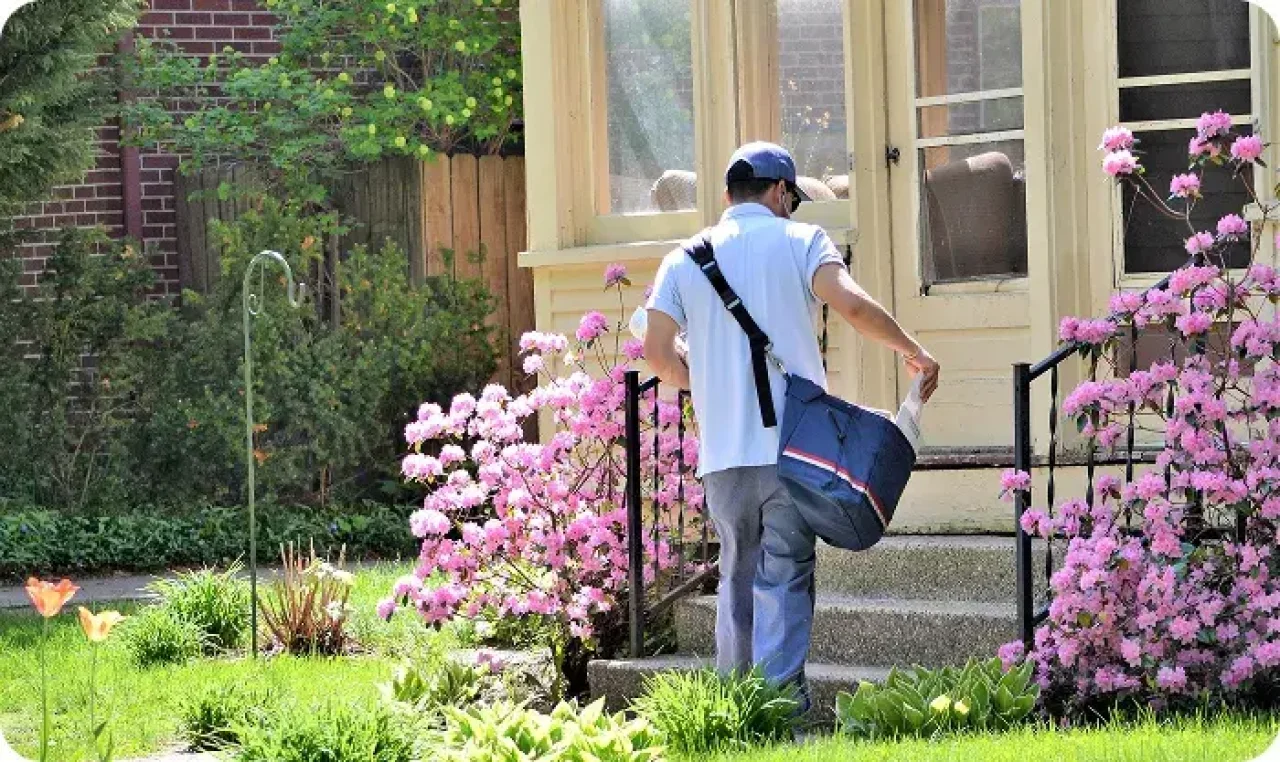 Mailman Carrying The Mail Door To Door